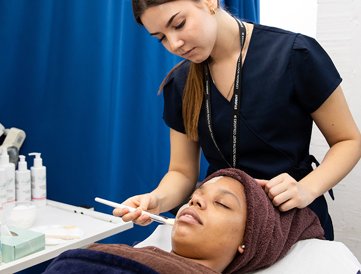 Students learning how to give a facial